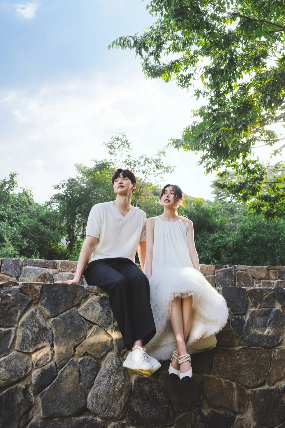 돌담 정원의 계절감과 동선을 살린 라이프스타일 커플 컷입니다. 자연스러운 움직임과 초록 배경을 원하는 커플에게 어울립니다.